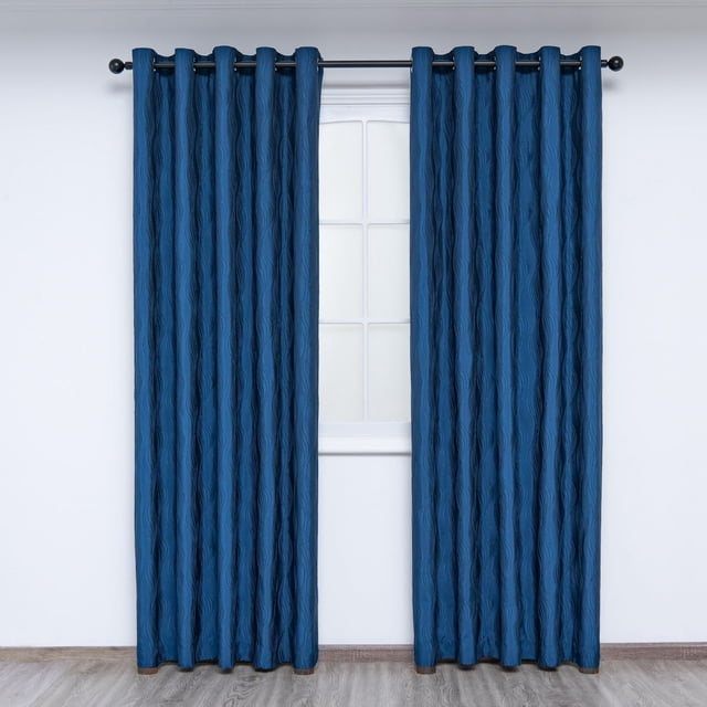 Gouchee Home Surf Curtain Panels in blue with a tone-on-tone textured wave pattern, fully lined with microfiber to filter light and protect color, featuring eight brushed silver grommets per panel on a black rod, each panel measuring 54 by 96 inches, shown hanging in front of a white window with light wood flooring, suitable for enhancing privacy and light control in living spaces.