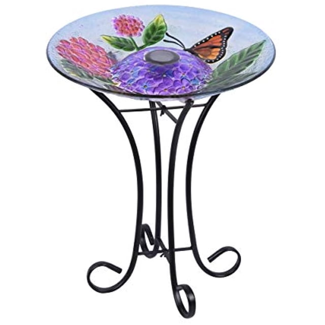 Hi-Line Gift 78415-D Bain d'Oiseaux en Verre à Fleurs à DEL Solaires avec Support Présentant un Bol en Verre Coloré aux Motifs Floraux et Papillons Complexes. le Bain d'Oiseaux Est Soutenu par un Support en Métal Noir Robuste et Comprend un Panneau à DEL à Énergie Solaire au Centre, Idéal pour la Déco de Jardin et l'Éclairage Nocturne.