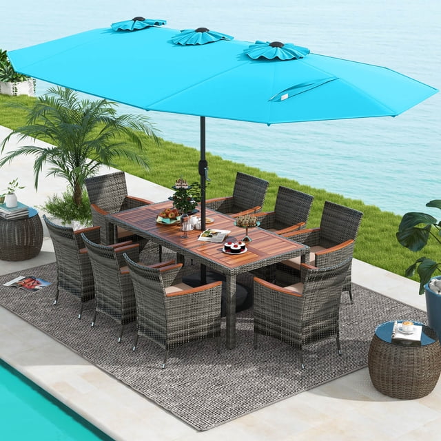 Costway 10 Pieces Patio Wicker Dining Set with Double-Sided Patio Umbrella, featuring 8 mix brown rattan armchairs with beige cushions and a large acacia wood table. The turquoise umbrella provides ample shade, making it ideal for outdoor dining and patio gatherings. Set is displayed poolside with greenery and a serene water view.
