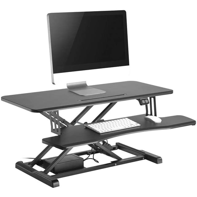 37.4" Electric Standing Desk, ergonomic height adjustable sit-standing desk converter by PrimeCables, designed with a black MDF and steel frame. Features a spacious 37.4" x 15.7" work surface, removable keyboard tray, and dual gas spring mechanism for smooth electric height adjustments. Includes a front slot for tablets or phones, cable management, and supports single or dual monitor setups. Height range is 6.1" to 18.9" with a weight capacity of 44 lbs.