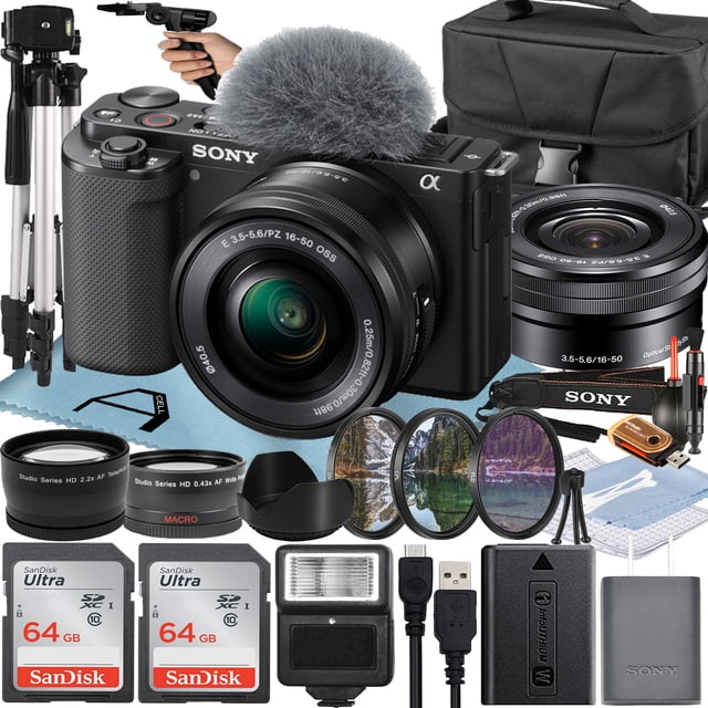 Sony Alpha ZV-E10 Mirrorless Vlog Camera in black with 16-50mm lens, accompanied by a complete accessory bundle including two 64GB memory cards, flash, tripod, camera case, pistol grip tripod, lens hood, cleaning kit, and auxiliary lenses. Designed for vloggers, it features a flip-out touchscreen, directional microphone with wind screen, and face-priority AE for optimized exposure. Perfect for content creators seeking enhanced image quality and creative control.