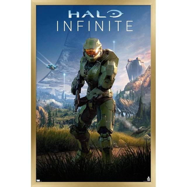 Halo Infinite - Primary Vertical Wall Poster, 22.375" x 34" featuring a centered green-armored soldier holding a rifle in a detailed mountainous landscape with futuristic structures and flying vehicles under a blue sky, framed in light wood. Ideal for home décor and gaming rooms.