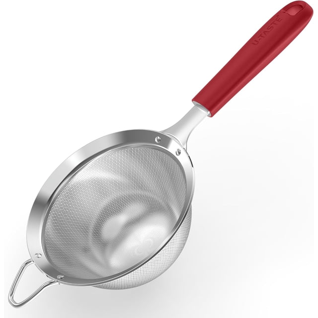 U-Taste Medium Fine Mesh Strainer made of 18/8 stainless steel with a 4.73-inch diameter and 30 mesh design. Features a sturdy riveted silicone handle in red for a comfortable grip. The deep, double-layered mesh is ideal for straining rice, quinoa, and other fine ingredients. Includes a small top loop for resting over bowls and a hanging hook for storage. Suitable for sifting flour, powdered sugar, and making beverages. Dishwasher safe and rust-resistant.