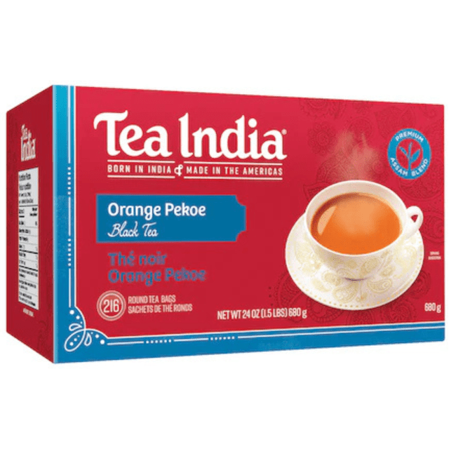 Tea India Orange Pekoe Black Tea box containing 216 foil-sealed round tea bags, red packaging with white and blue text, showing a steaming cup of amber black tea on a white patterned saucer, net weight 24 oz (680 g), suitable for daily fresh black tea brewing.