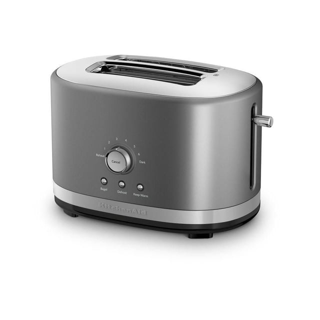 KitchenAid® 2-Slice Toaster in matte silver with two wide slots, a central dial with seven shade settings including bagel, defrost, reheat, and keep warm, plus a side lever, designed to save counter space and toast various breads.