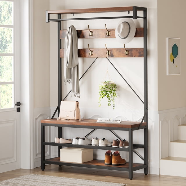 Garvee Industrial 3-Tier Hall Tree with Bench, 39.9-inch coat rack and shoe storage, featuring a rustic brown wood finish and black powder-coated steel frame. Includes eight hooks, a hanging bar, a top shelf, and three open shelves for shoes. Shown in a bright entryway with shoes, a bag, and a hanging plant for added decor.
