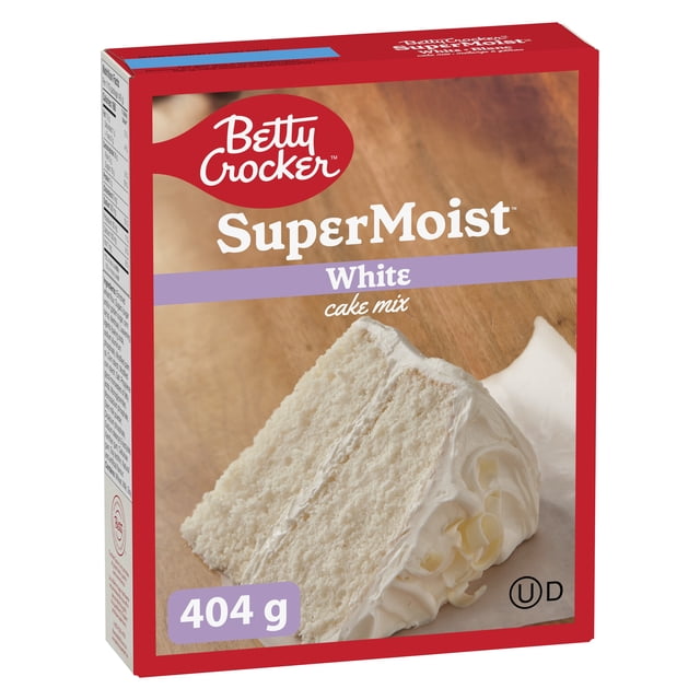 Betty Crocker Super Moist White Cake Mix box with red border showing a front view of the packaging featuring a two-layer white frosted cake slice on a wooden surface, containing 404 g of easy-to-bake cake mix for moist white cakes.