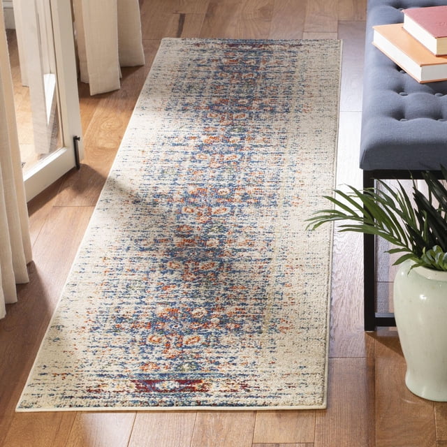 Safavieh Monaco Annabelle Tapis Vintage Présentant un Motif Persan Vieilli dans des Tons Bleu, orange et beige Atténués, Tissé Mécaniquement en Polypropylène durable avec pile à Boucles Mixtes, Exposé sur un Plancher de Bois Franc à Côté d'Un Banc Capitonné Gris et d'Une Plante en Pot Verte, Convient pour Ajouter un style Bohème Chic aux Intérieurs de la Maison.