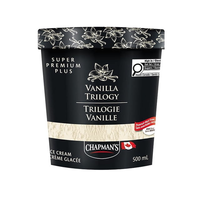 Chapman's Super Premium Plus Vanilla Trilogy Ice Cream in a 500 mL tub with a black lid featuring vanilla flower illustrations. The black container has a cream textured band and labels it as peanut, nut, and egg free, kosher, and made with 100% Canadian dairy. It includes a Canadian flag and Health Canada nutrition warnings. This ultra-creamy ice cream is suitable for those seeking a premium vanilla treat free from common allergens.