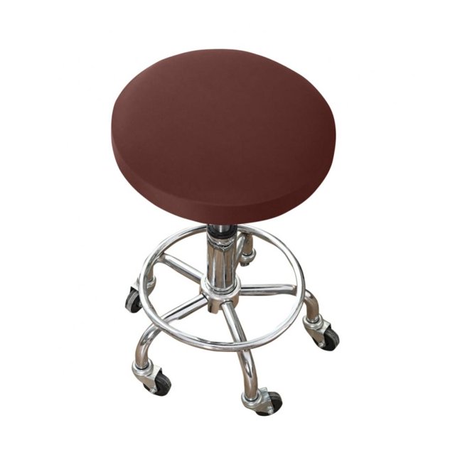 Round Bar Stool Seat Cover in a solid brown color, made of stretchy artificial leather with elastic edges, shown fitted on a metal bar stool with a chrome finish and caster wheels. Designed for 12-15 inch diameter stools, this washable slipcover protects against stains, wear, and scratches while giving a refreshed look to bar stools, kitchen stools, or spa stools.