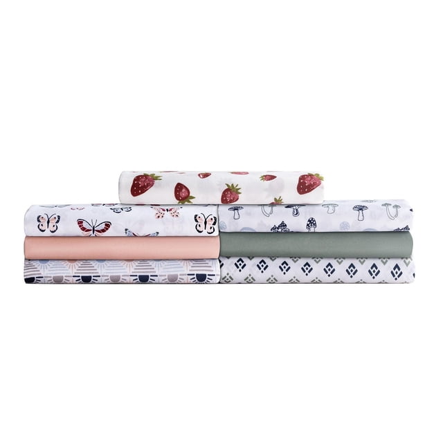 Mainstays Soft, Easy Care, Microfiber Sheet Set with folded sheets stacked showing patterns of strawberries, butterflies, mushrooms, geometric shapes, and solid colours, made from brushed microfiber for durability, wrinkle resistance, and easy machine washing.