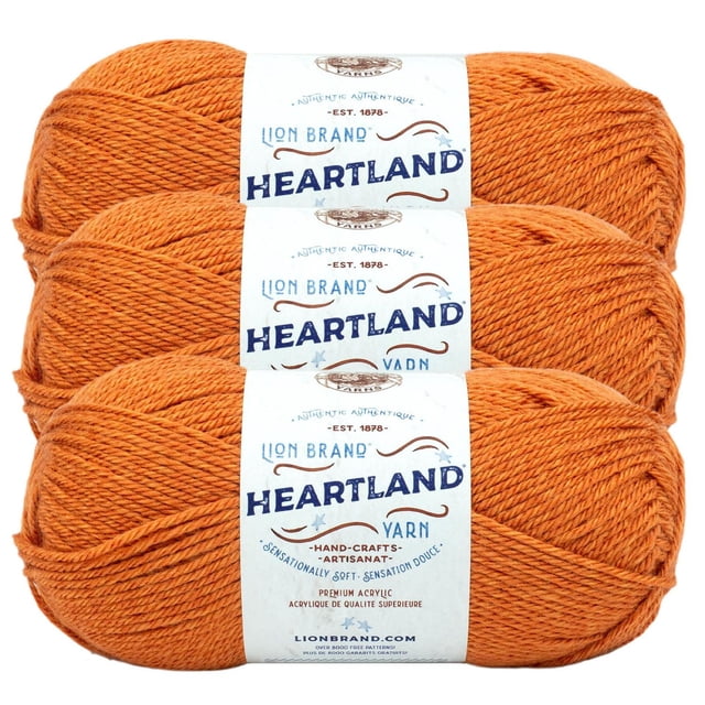 Lion Brand Yarn Heartland Yarn 3Pack with three skeins of medium worsted weight acrylic yarn in heathered orange, each wrapped in a white label with brand and product details, suitable for knitting, crochet, and home décor crafts.