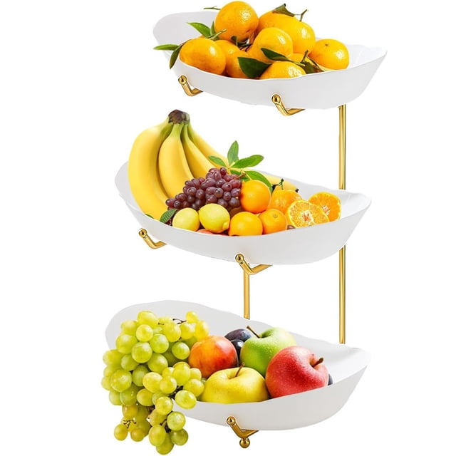 Fruit Basket for Kitchen Kitchen Counter Fruit Bowl 3-Layer Acrylic Fruit Basket with Service Bowl and Metal Bracket for Fruit and Vegetable Storage. The image shows a three-tiered fruit basket with white acrylic trays supported by a gold metal bracket. Each tier is filled with a variety of fruits, including oranges, bananas, grapes, and apples. The vertical design maximizes counter space, making it ideal for organizing fruits and snacks in a compact and decorative manner.