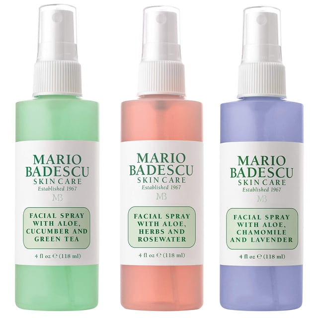 Mario Badescu Spritz Mist and Glow Facial Spray Collection, 3 Piece Set featuring three 4 fl oz (118 ml) bottles of facial sprays. Includes Aloe, Cucumber and Green Tea (green bottle), Aloe, Herbs and Rosewater (pink bottle), and Aloe, Chamomile and Lavender (purple bottle). Each spray is designed for hydration, toning, and refreshing the skin. The bottles are arranged side by side against a white background.