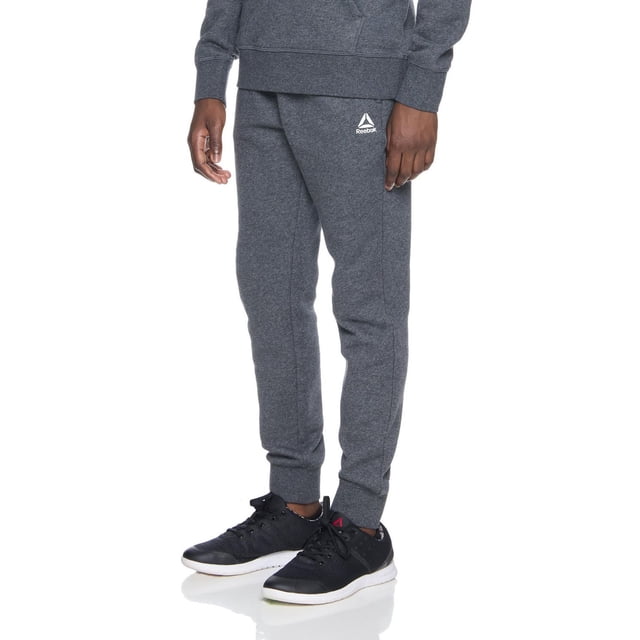 Reebok Jogger en Molleton Delta pour Garçons en Tissu Polaire de Base Gris Foncé avec Taille Élastique, Cordon de Serrage Intérieur, Poignets Côtelés, Deux Poches Latérales et Poche Zippée Collée, avec le logo Delta Blanc sur la Cuisse Gauche, Idéal pour les Tenues Décontractées Ou le Sport.