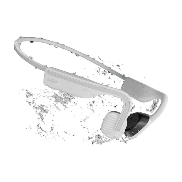 Shokz OpenMove white open-ear Bluetooth headphones with a flexible titanium frame and bone conduction pads, shown with water droplets highlighting IP55 sweat resistance, designed for sports and active use and suitable for hands-free calls.