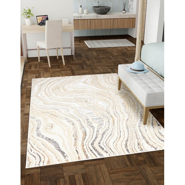 ECARPET Mercan Contemporary/Modern Area Rug with beige, cream, and gray marble-inspired fluid patterns on dark parquet flooring in a bedroom featuring a light gray upholstered bench with a blue hat, wooden desk with beige chair, and floating vanity with stone vessel sink and blue tile backsplash, suitable for adding modern organic elegance to living spaces.
