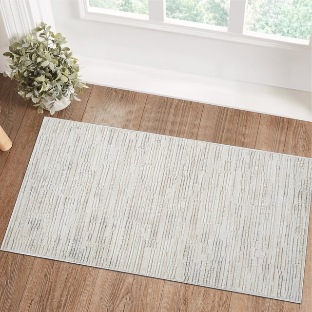 Rug Branch Astra Modern Indoor Area Rug in beige cream with an abstract linear pattern, machine-woven polyester with jute backing, placed on a wooden floor near a window and a potted plant, ideal for kitchen mats, dining room, or living room areas.