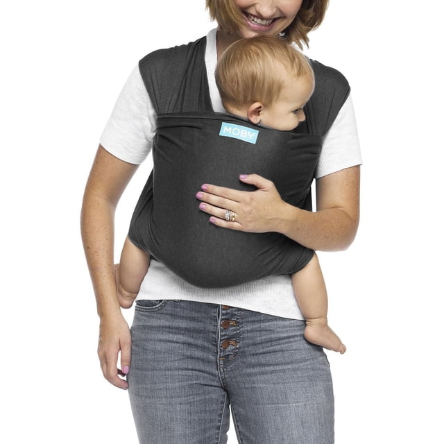 MOBY Wrap Baby Carrier - Evolution Wrap in dark grey worn by a person carrying a baby facing inward, made of soft, breathable viscose and cotton blend fabric with stretch, providing ergonomic support and hands-free convenience for newborns and infants up to 33 lbs.