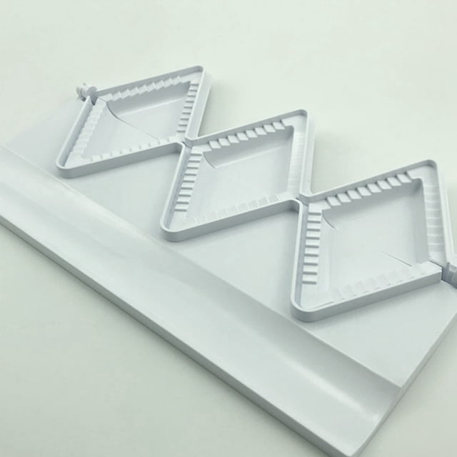 Kitchen Tools Dumplings Maker with 3 triangle moulds for making pierogies, samosas, ravioli, dumplings, pies, empanadas, and meatballs. The white plastic tool features a decorative crimped edge design for sealing fillings and a backside circle for cutting dough to size. Dimensions are 28.5 x 11 x 2.6 cm.