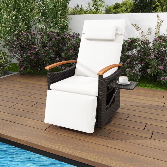 Costway Outdoor 360° Swivel Rattan Recliner Chair Patio Wicker Chaise Lounge Chair in white, featuring a mix brown hand-woven PE rattan frame with acacia wood armrests. The chair includes a 150° adjustable backrest and footrest, a 360° swivel base, and a foldable side table for added convenience. Cushions and a headrest with removable covers provide comfort, while the sturdy design supports up to 400 lbs. Shown on a wooden deck near a pool with a lush garden backdrop.