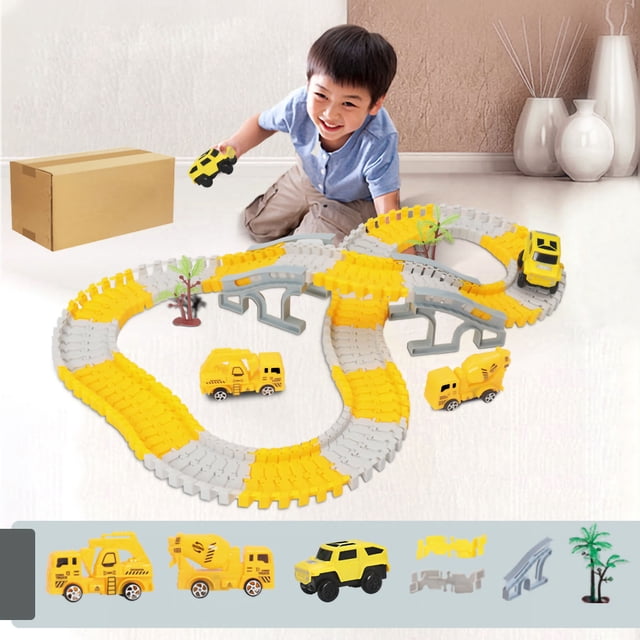 Construction Race Tracks For Kids Race Track Toy Flexible Track Toy Set Electric Track Toy Car. The set features a yellow and grey flexible track with bridge components, construction vehicles like a dump truck, excavator, and SUV, and decorative palm trees. A child is playing with the set in a well-lit indoor space.