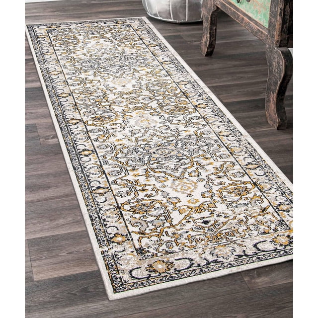 ECARPET washable oriental area rug and runner featuring a traditional intricate pattern in muted gold, black, and grey on a low pile polyester base, measuring 2'6" x 8'0", placed on dark wood flooring beside rustic furniture, designed for durability and easy machine washing, ideal for kitchens, bedrooms, and hallways, also suitable as a decorative runner in entryways.