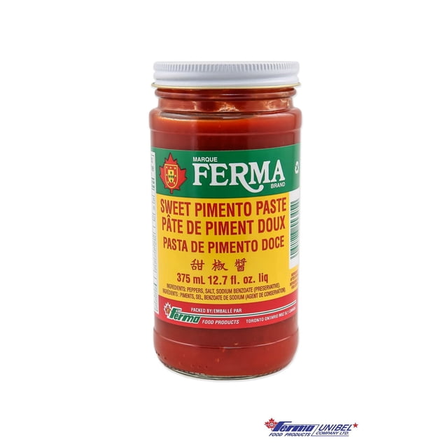 Ferma Sweet Pimento Paste in a clear glass jar with a white metal lid, showing rich red paste inside. The green and yellow label includes multilingual text and states 375 mL (12.7 fl. oz.). This savoury pantry food paste enhances meat, poultry, fish, seafood, and sauces and is often used as a flavour enhancer in cooking.