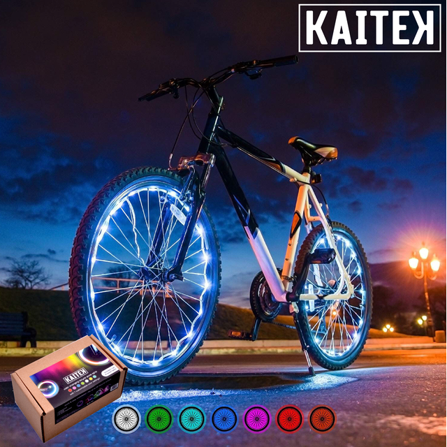 IFRENCHIE LED Bicycle Wheel Accessory Light for 2 Wheel, Colour-Changing, installed on a black and white bike. The vibrant, colour-changing LEDs illuminate the wheels, enhancing cycling safety and style during nighttime rides. Features waterproof design and two lighting modes: steady and flashing. Ideal bike accessory for increased visibility. Package includes lights for two wheels.