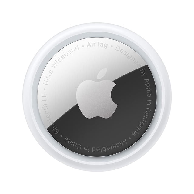 Apple AirTag shown from a centered top-down view with a circular polished silver metal face displaying the Apple logo, surrounded by a white plastic rim. It features Bluetooth LE and Ultra Wideband technology for precise tracking and is designed by Apple in California, assembled in China.