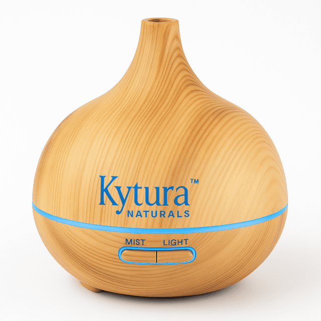 Kytura Naturals KN Aromatherapy Diffuser 150 ML with a natural wood grain finish, featuring a compact, rounded design. The diffuser includes ultrasonic mist technology, auto shut-off, and 7 colour LED lights. Visible controls for mist and light are located on the front. Accessories include a USB cable, USB charger, plug wall adapter, remote control, and user manual.