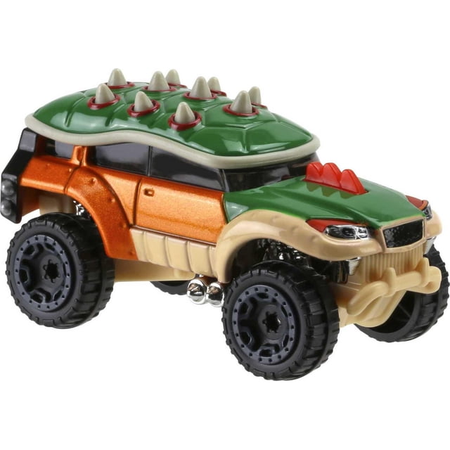 Hot Wheels Super Mario Bowser Vehicle toy car shown at a 3/4 front angle with a green roof featuring white spikes on red bases, metallic orange body, beige fenders, and large black off-road tires with detailed rims, suitable for racing or collecting.