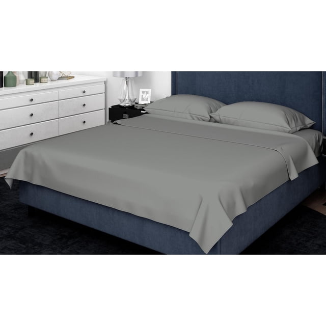 Johnson Home 500 Thread Count Liquid Cotton Sheet Sets in grey on a king bed with navy blue upholstered headboard. Includes flat sheet and two pillowcases with 500-thread count sateen weave, wrinkle-resistant and breathable for temperature regulation. Features extra deep 15-inch pocket fitted sheet with elasticized hem. Ideal for year-round comfort and often used for guest rooms due to its smooth, durable fabric.