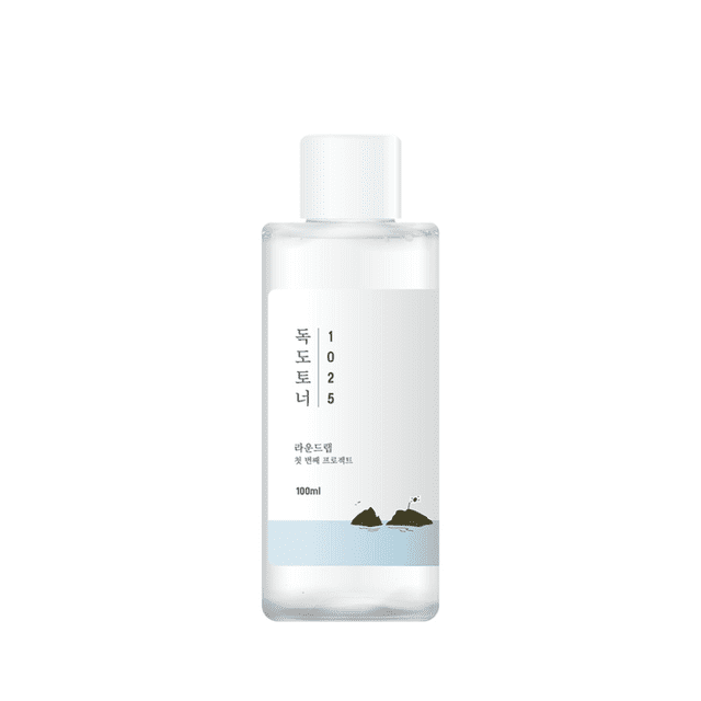 Round Lab - 1025 Dokdo Toner (100ml) in a clear plastic bottle with a white cap. The label features minimalist Korean text and an illustration of Dokdo Island on a light blue background, emphasizing its inspiration from the island's pure waters. Designed for deep hydration and skin balance, suitable for all skin types.