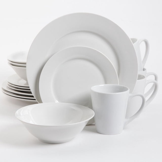 Gibson Home Noble Court 16 Piece Dinnerware Set in white porcelain with round rim shape, including four 10.5-inch dinner plates, four 7.5-inch dessert plates, four 7-inch bowls, and four 12 oz mugs, all dishwasher and microwave safe, arranged stacked on a white surface, suitable for everyday dining and casual entertaining.