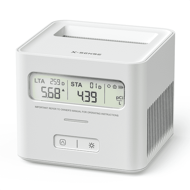 X-Sense Radon Gas Detector Monitor for Home, a compact white device with an LCD display showing real-time radon levels and cumulative averages. Designed for continuous, silent monitoring, it features a reset button for reusability, 2-year battery life, and offline functionality. Suitable for bedrooms, nurseries, and other indoor spaces as a reliable home safety device.