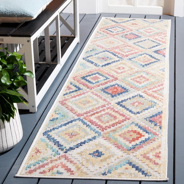 SAFAVIEH Cabana Carina Geometric Indoor/Outdoor Area Rug with a rectangular shape featuring a multicolored diamond pattern in muted blue, red, beige, and cream tones, placed on a gray wooden deck floor beside a white bench with a blue cushion and a green potted plant, made from durable synthetic yarns resistant to weather, mold, and sun fading, suitable for busy indoor or outdoor areas like patios and porches.