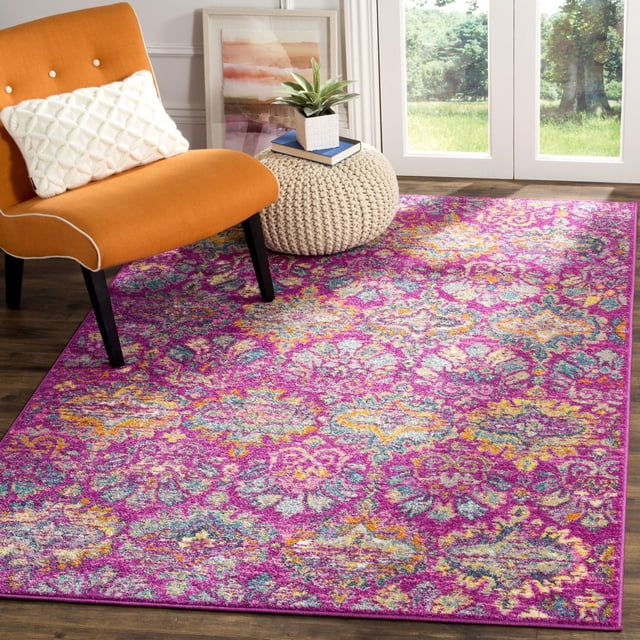 Safavieh Madison Britton Geometric Floral Area Rug with vibrant purple, yellow, teal, and orange floral geometric patterns on a dark hardwood floor, shown with an orange accent chair and cream knitted pouf near glass doors in a bright room, ideal for enhancing contemporary home decor.