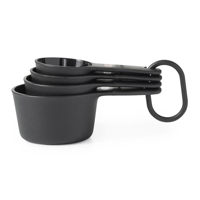 OXO Softworks Measuring Cup Set four BPA-free measuring cups with color-coded measurement labels and clear markings for 60 mL, 80 mL, 118 mL and 236 mL; black plastic with wide ergonomic handles, hanging loops and a storage ring, dishwasher-safe, often used for portioning baking ingredients or measuring craft supplies.