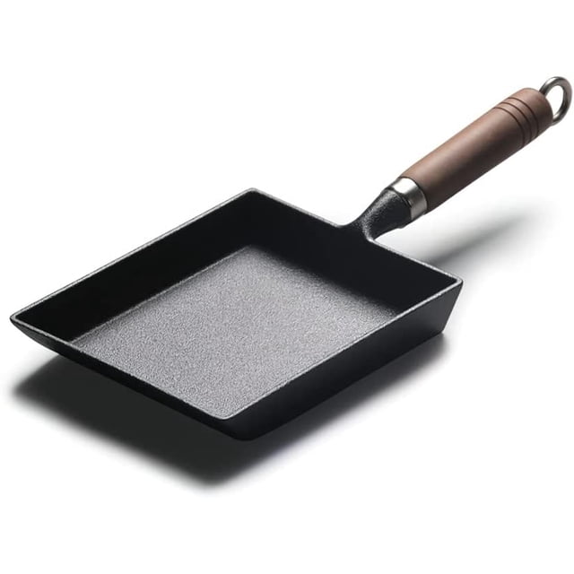 Japanese Omelette Pan Cast Iron Wooden Handle featuring a rectangular pre-seasoned cast iron skillet with a textured black surface and a sturdy wooden handle. The pan measures 7 × 5.9 × 1.5 inches with a handle length of 7.5 inches, ideal for making egg rolls, casseroles, and other dishes. Suitable for all stovetops, it offers excellent heat conduction and storage performance. Often used as a serving tray for plating food aesthetically.