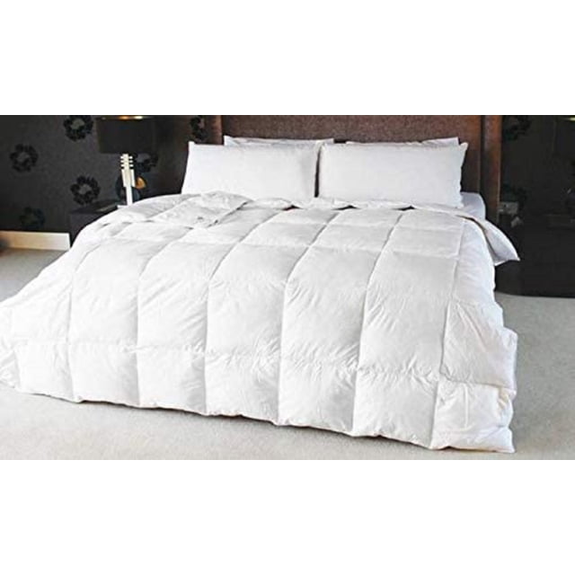 White Duck Feather Duvet with 100% Cotton casing displayed on a queen-sized bed in a modern bedroom. The duvet insert features a quilted design with a 250 thread count cotton cover, offering year-round warmth and coziness. Suitable for dry cleaning only.
