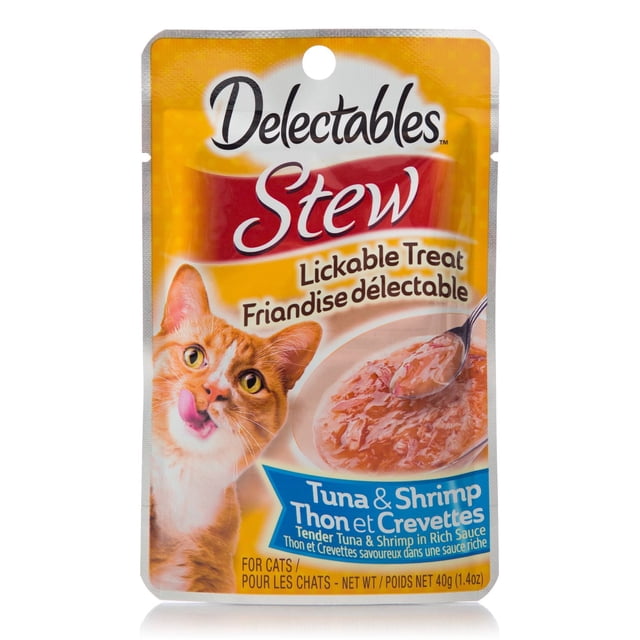 Hartz Delectables™ Stew Lickable Tuna & Shrimp CAT Treats pouch showing an orange tabby cat licking its lips next to a bowl of tender tuna and shrimp in rich sauce, with bilingual English and French text on a yellow and red background, ideal as a soft and chewy cat treat.