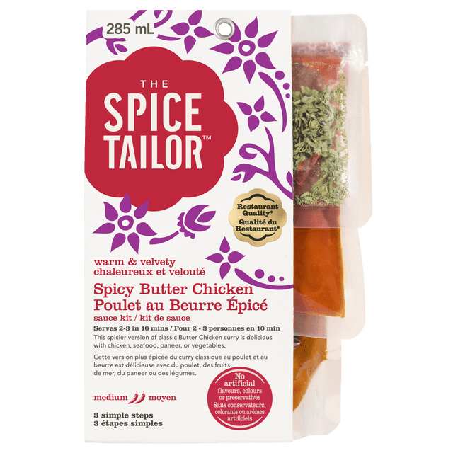 The Spice Tailor Spicy Butter Chicken sauce kit in a 285 mL white package with purple floral design and red logo, containing separate pouches of spices and sauce, medium heat, ready in 10 minutes for 2-3 servings, with no artificial flavours or colours.