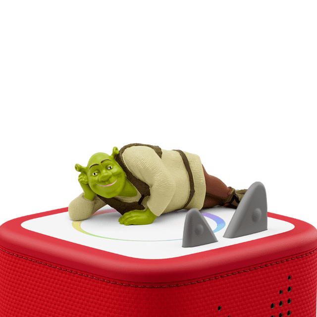 tonies Shrek Audio Play Figurine showing Shrek lying on his side wearing a cream sweater and brown vest on a red Toniebox base with grey ears, designed for screen-free educational audio entertainment and cognitive skill development for children.