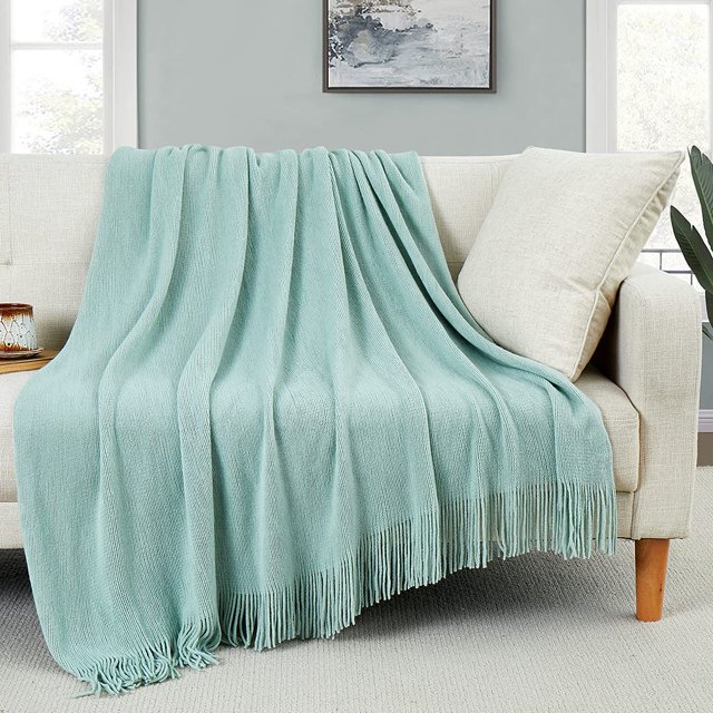 HTOOQ Couverture Jetée Décorative en Tricot avec Franges Vert Pâle, Drapée sur un Canapé beige dans un Salon Douillet. Fabriquée en Acrylique Façon Laine, Cette Couverture à Pompons Douce et Confortable Est Parfaite pour Canapés, sofas, Lits Ou comme Pièce d'Accent de Déco Maison.
