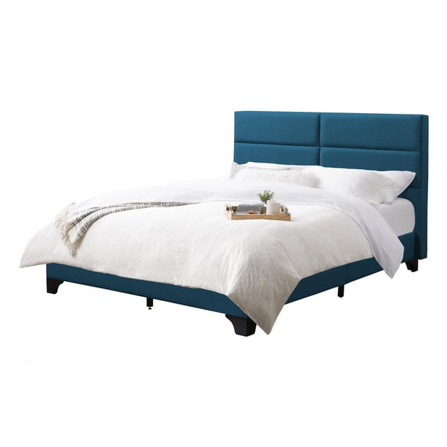 CorLiving Bellevue Upholstered Adult Full Bed Frame with Wide-Rectangle Tufted Headboard and Slats in blue fabric, featuring a wide padded headboard with horizontal seams, black solid wood legs, and 14 wooden slats that provide mattress support without a box spring, shown with white bedding and a wooden tray with a small plant and cup.