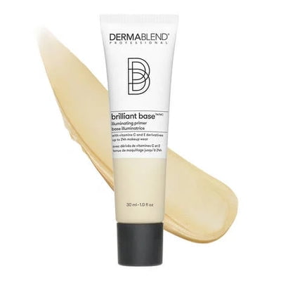 Dermablend Brilliant Base, Illuminating Primer in a 30 ml (1.0 fl oz) tube. The creamy, lightweight formula is enriched with vitamins C and E, designed to brighten, hydrate, and smooth the skin while extending makeup wear for up to 24 hours. The product is displayed alongside a swatch of its light, creamy texture.