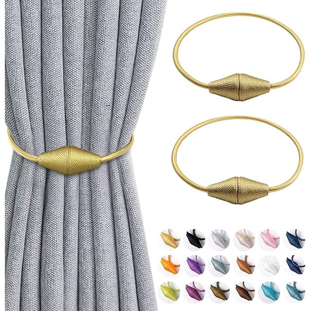 ZYNERY 2 Pcs Magnetic Curtain TieBacks in gold, featuring durable polyester-silk rope and nickel-plated magnets. The tiebacks are shown securing a grey curtain, with their sleek design and adjustable 46 cm length suitable for light or heavy drapes. Includes a variety of color options displayed below.