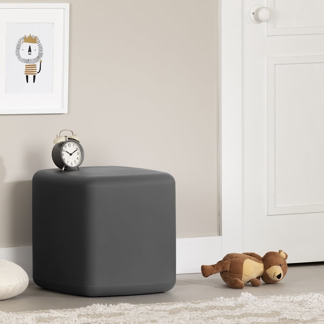 South Shore Sweedi Nightstand for Child in dark gray with cubic, water-resistant polyethylene resin design and smooth rounded edges, shown in a child's room with a black and silver alarm clock on top, beige wall with framed lion artwork, white door, and a brown plush bear on the floor, ideal for bedside storage or playroom use.