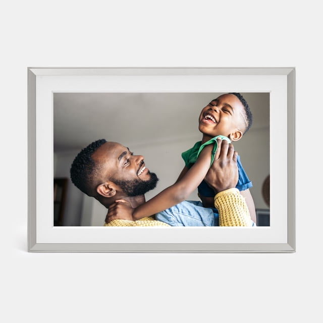 Aura Carver Mat freestanding landscape digital frame with color-calibrated 10.1” HD 1280x800 display, slim rectangular silhouette showing a family photo and video still, WiFi-connected with built-in speaker and smart photo curation; often used for rotating recipe or travel slides.